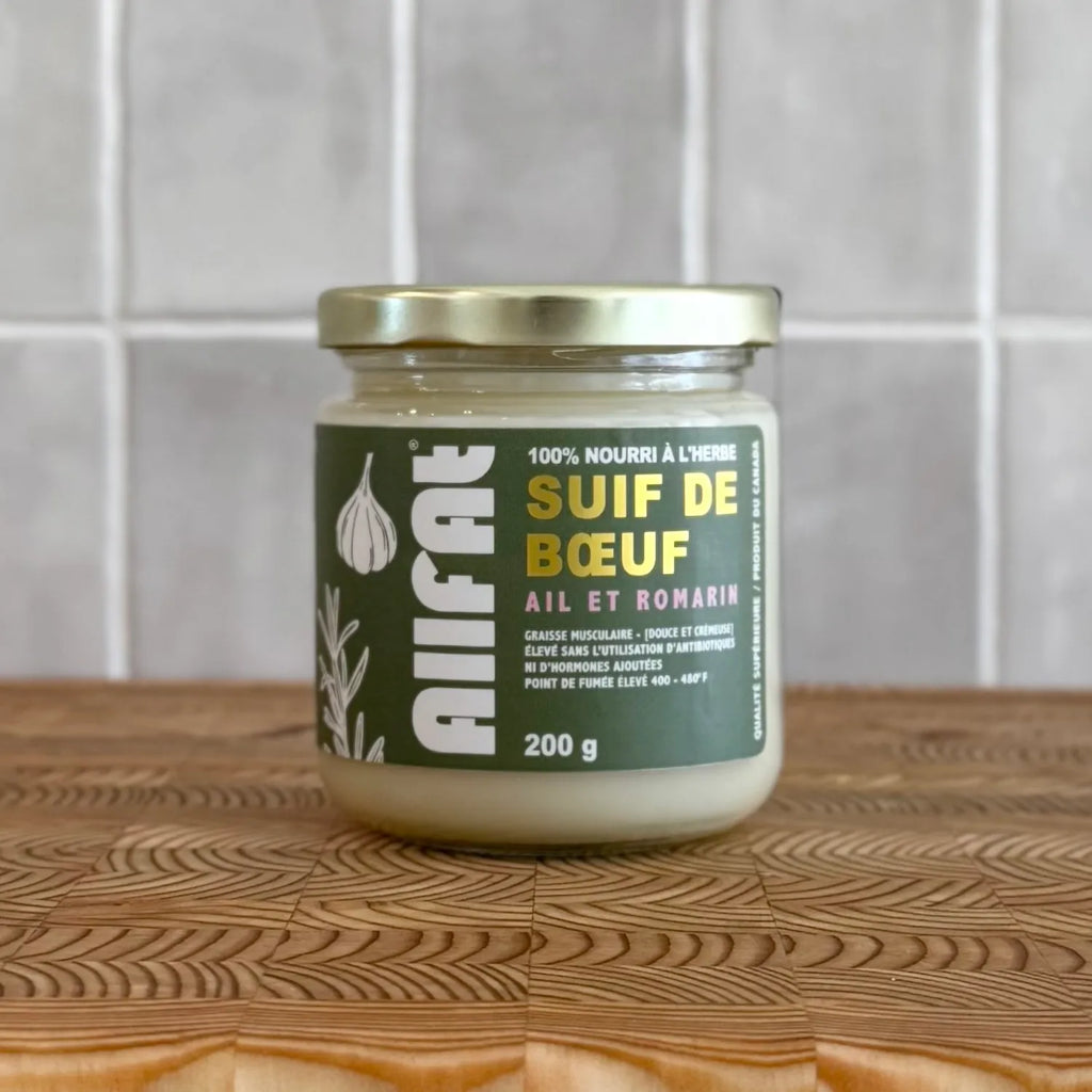 Jar of 'Suif de Béuf' allfat beef tallow on a wooden surface with a tiled wall background