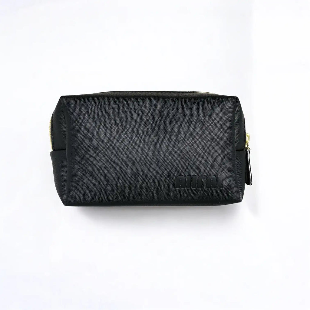 Black travel leather bag with gold zipper on a white background