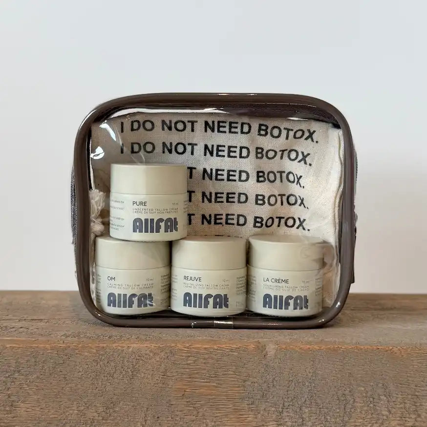 Set of tallow skincare products in a clear pouch with text and branding.