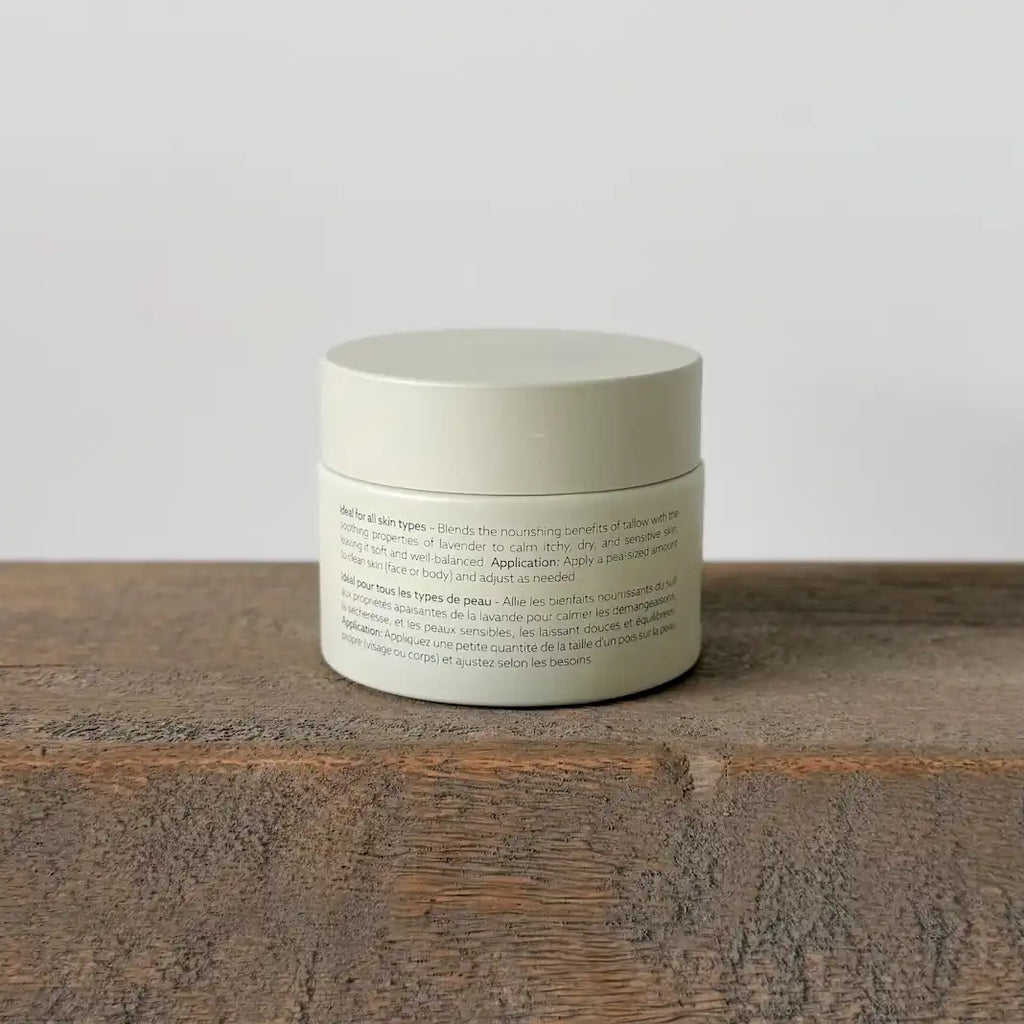 Cream jar container with text on a wooden surface and light gray background